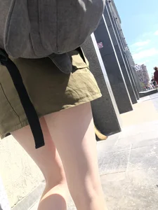 Cute Candid Teen Girl in a Skirt With a Backpack Passing By on the Street - Very Pale Legs With Smooth Skin