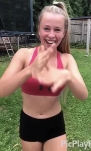 Fit gymnast girl in spandex shorts training in the backyard