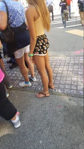 Girl in shorts and sandals on the street busted