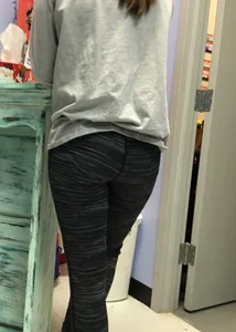 Ass standing around in tight grey patterned leggings