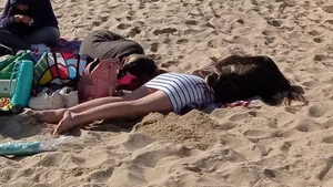 Beautiful Teen with Miniskirt resting on the beach