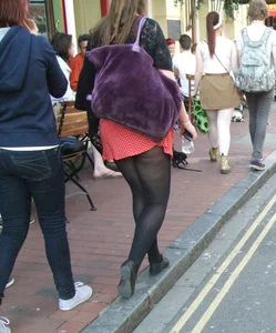 Girl in a pink skirt and stockings accidentally showing some cheek