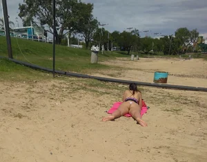 White thong brunette babe laying out on the beach with her dog