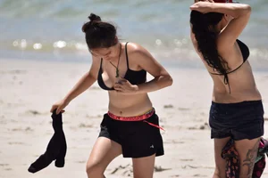 Beach girl can't keep her tits in her bikini