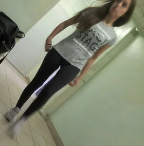 Young Candid Girl in Leggings Walking Down the Corridor