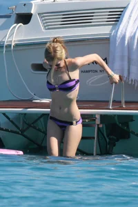 Avril Lavinge looking sexy in purple bikini on a boat