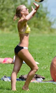 Sexy blonde girl in the park playing volleyball in her skimpy bikini