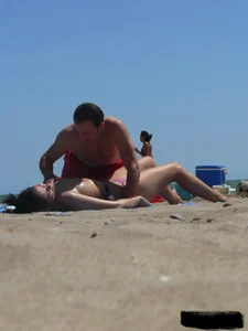 Purple thong topless lady on the beach gets oiled up by her husband