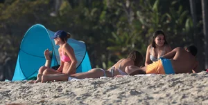 Two sexy friends out on the beach in bikinis