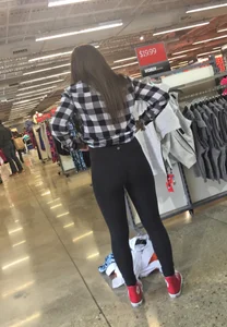 Cute Girl in Yoga Pants Bending Over at the Store