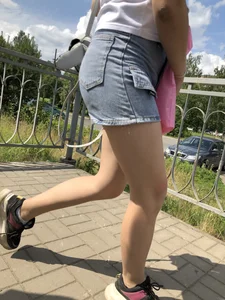 Cute Girl in Denim Shorts Walking Down a Railway Station Gallery