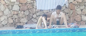 Very skinny girl by the pool