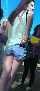 Skinny girl with purple hair in denim shorts