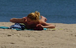 Sexy ass blonde milf on the beach in a thong with cameltoe and bending over