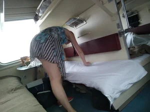Girl in a Dress Bend Over while Making Bed in the Train Sleeping Car Creepshot