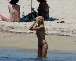 Small boobed topless milf on the beach