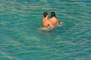 FKK Nudists playing in the water with floater