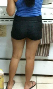 Asian girlfriend doing dishes in spandex shorts