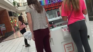 Little blonde teen in grey leggings at the mall with her friends