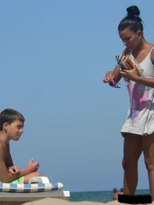 Hot ass topless beach girl with great tits lets her little brother oil up her ass in thong bikini