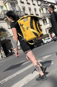 Amazing cute candid food delivery girl with lots of tattoos crossing the street