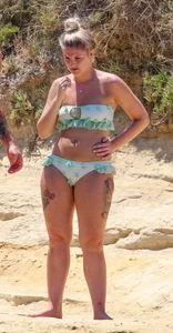 Tattooed thick blonde babe in a bikini