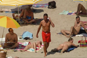 Girls on a nude beach in Sitges, Spain