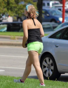Blonde girl in glasses with a thick booty in green shorts