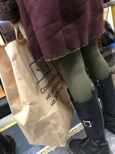 Cute candid winter girl in a public bus, closeups of her slim legs in green pantyhose and boots