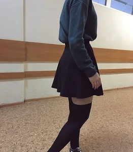 Candid teen wearing a skirt and black stockings