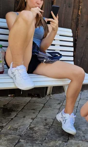 Amazing candid teen in mini shorts sitting on a street bench spreading her legs