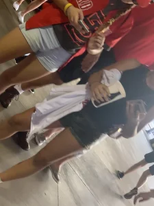 Bunch of girls in various outfits at a Cardinals baseball game