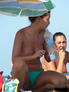 Bunch of sexy babes on the beach topless and in thong bikinis
