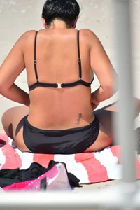 Blonde and brunette on the beach looking sexy in their bikinis