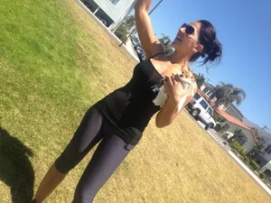 Hot brunette babe in leggings walking her dog with a nice ass and some cleavage