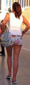 Girl in little floral shorts showing her cheeks