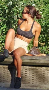 Tanned fitness woman showing off her toned physique & amazing butt