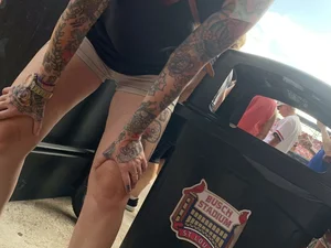 Bunch of girls in various outfits at a Cardinals baseball game