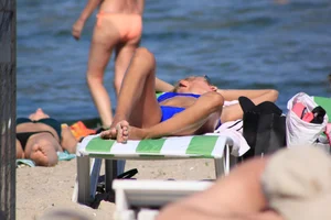 A couple sexy girls laying out on the beach