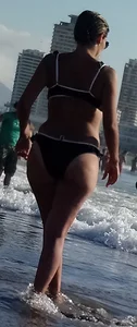 Milf with a big booty in a bikini at the beach