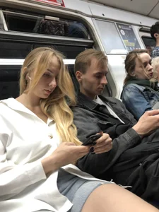 Candid girl in denim shorts sitting in a subway train, hot legs with pale skin