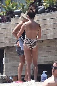 Ashley Tisdale in cheetah print swimsuit on the beach in Malibu