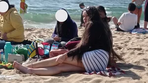 Beautiful Teen with Miniskirt resting on the beach