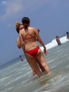 Thick girl and her skinny friend in bikinis at the beach