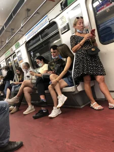 Hot Girl With Gorgeous Legs in Jean Shorts And Sneakers Sitting in a Subway Train With Crossed Legs - Touching And Swinging Her Legs