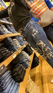 Teen in tight jeans looks to buy another pair