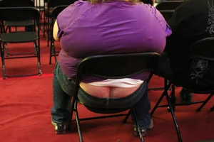 An Obese Woman in Jeans, Her Ass Crack Visible From Under Jeans