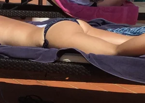 Blonde laying out in a blue bikini with a sexy body