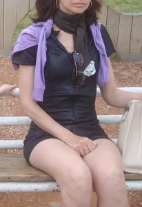 Sexy young milf in a short dress sitting on a bench, she's got hot legs