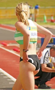Blonde Athlete Adjusting Spandex Candid
